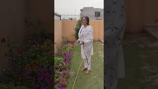 Dr Sughra Sadaf watering the flowers