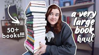 a very large over the top book haul 50+ books