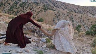 Zulikha nomadic woman ofIran cooking khagine and stone wallAbstract