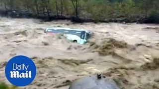 Shocking moment monsoon floods cause bus to be swept away