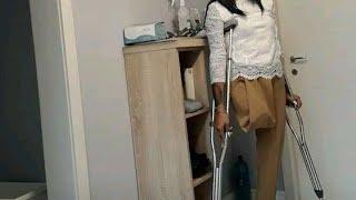 A beautiful woman with an amputated leg walking on one crutch #amputado