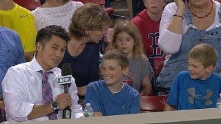 Boy hands souvenir over to girl behind him