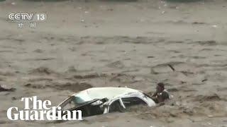 Man rescued from car swept into river as Typhoon Doksuri hits China