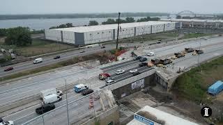 The first cars drive over the temporarily patched lanes of I-95 on Friday afternoon