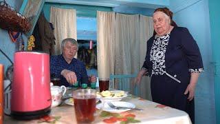 Happy elderly couple lives in the taiga forest far from civilization. Life in Russian villages