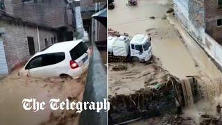 Cars washed away and bridges collapse in flood-hit southern China after powerful storms