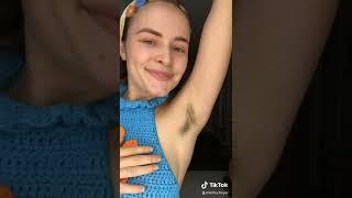 the girl shows hairy armpits. unshaven armpits of girls. body positive. hairy unshaven armpits