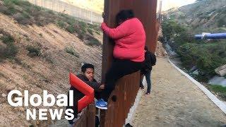 Migrant families continue to spill over Tijuana border fence head to U.S.