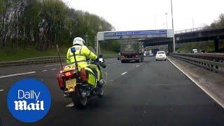 Terrifying moment police motorbike swerves into fast lane on M8 - Daily Mail