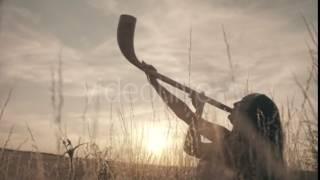 Girl Blowing a Trumpet in the Sun Among the Wheat