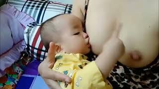 Beautiful baby and cute mom Breastfeeding By