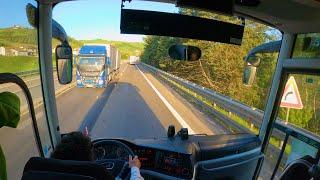 Driving bus narrow road with trucks Italy