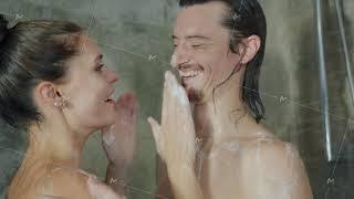 Husband and wife taking shower together washing talking and having fun with soap foam