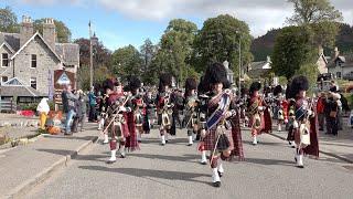 Massed Pipes and Drums march to the 2019 Braemar Gathering in Royal Deeside Aberdeenshire Scotland