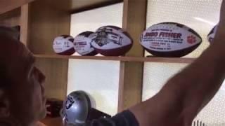 Texas A&M head coach Jimbo Fisher shows off his commemorative footballs in his office