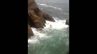 Daring Cliff Jumper Leaps over Rocks