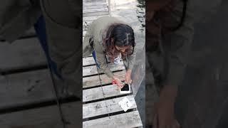 Canadian girl who is scared of spiders baits her own fishing hook with worms. Worms for bait.