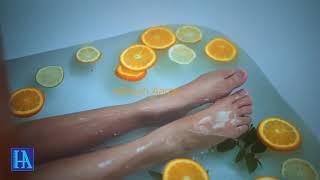 beautiful girl taking bath with Fruits in tub