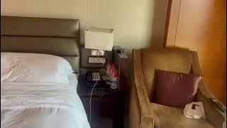 in a Hangzhou intercontinental Hotel room showing the bed and Two Telephone ️TV  iPad And Phone