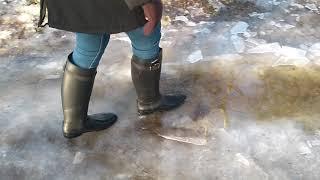 Walking in puddle in rubber boots