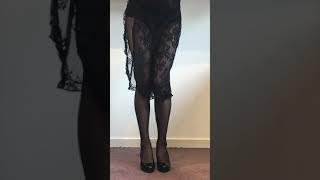 Crossdressing in black fishnet tights and lace nightie.