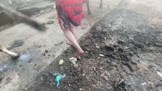 Barefoot girl steps on cow dung