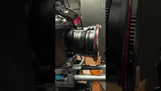 BTS setting up a talking head shot in the “red chair” set.