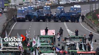 Farmer protests Armoured police vehicles block highway as tractors push to reach Paris