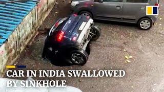 Parked car in India swallowed by sinkhole after heavy rain