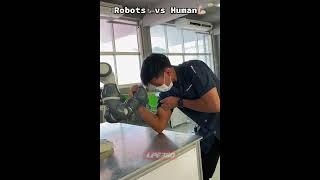 Guy arm wrestles against robot arm