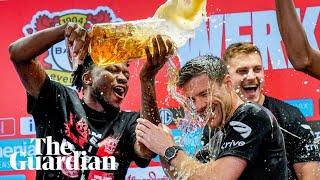Bayer Leverkusen players shower Xabi Alonso in beer during press conference
