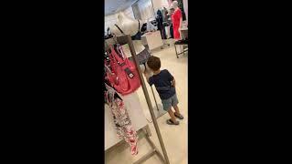 Kid cheekily feels a mannequins butt