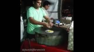 A chick drops out from an egg to be fried at a street food stall in India