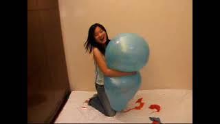 Asian Girl Hugs Hard to Pop a Blue Balloon