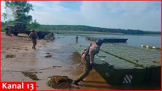 Ukrainian army prepares for attack by moving heavy equipment across river with pontoon bridges