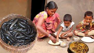 A santali tribe mother cooking small fish curry recipe for her childrens  bengali community life