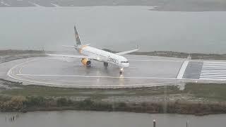 Condor powerful take off at Corfu during a rainy morning filmed from a hotel balcony