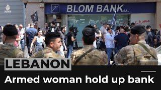 Lebanon economic crisis Armed woman and activists hold up a bank