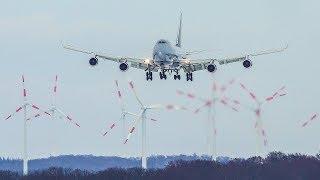 BOEING 747 LANDING with lots of WIND TURBINES in the background 4K