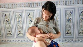 15 year old single mother holds her baby watching the rain and breastfeeding