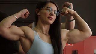 Beautiful muscular woman flexing her biceps