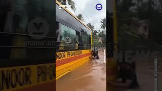 Locals rescue school bus stuck in flooded road