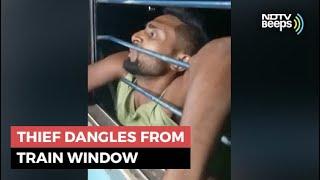Watch Thief Dangles From Train Window As Passengers Grab Arms  NDTV Beeps