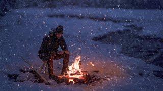 Relaxing by a Crackling Campfire near the Frozen River in the Mountains with Snow Falling Quietly