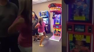 WOMAN PUNCHES TOP SCORE IN ARCADE 