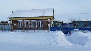 A hard day for a farmer in a winter village in Russia