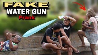 FAKE WATER GUN PUBLIC PRANK   with wonderful voice