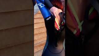 Girl putting on Triathlon Wetsuit - close up