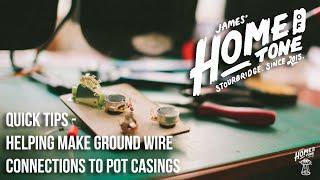 Helping prepare and make ground wire connections to guitar pot casings