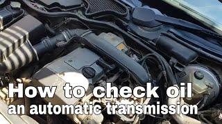 How to check the oil in an automatic transmission equipped with a dipstick?